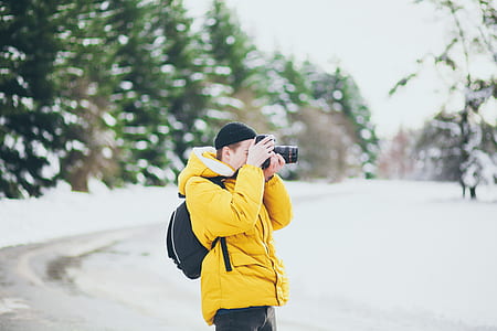 man taking photo using camera thumbnail