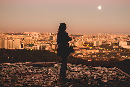 silhouette of woman holding bag thumbnail