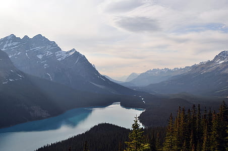 black rocky mountain near body of water during daytime thumbnail
