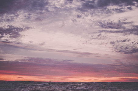 body of water under purple and orange sunset sky thumbnail