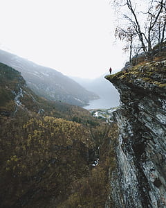 person standing on top of the cliff thumbnail