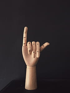 brown wooden hand sign on table thumbnail