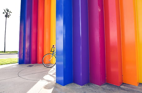 bicycle parked between multicolored walls thumbnail