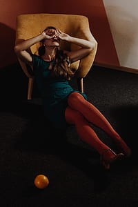 woman leaning on brown armchair covering her eyes thumbnail