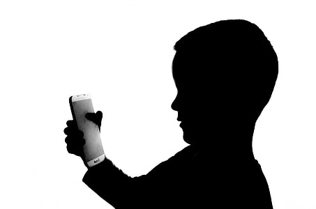 boy holding smartphone thumbnail