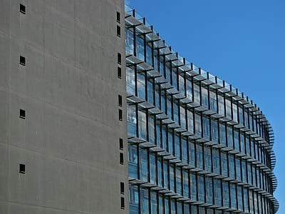 Grey Concrete Building With Blue Windows thumbnail