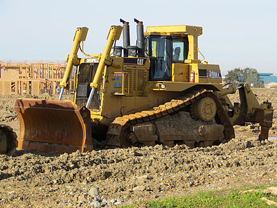 yellow bulldozer near tree thumbnail