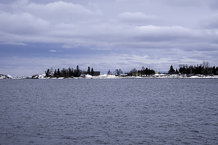 Peninsula with trees and houses on Lake Superior in Grand Marais, Minnesota thumbnail