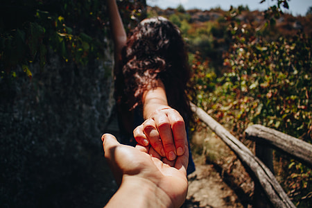 person holding woman in black suit during day time thumbnail