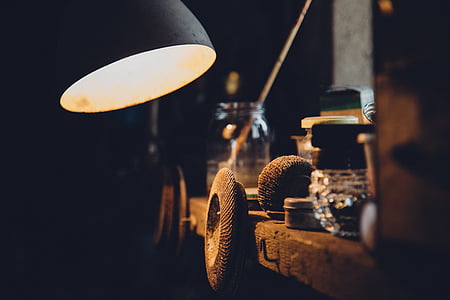 turned-on table lamp near of glass bottle thumbnail