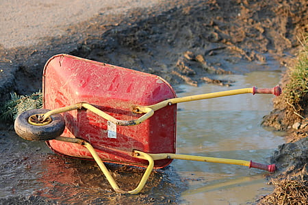 red wheelbarrow on mud thumbnail