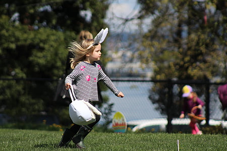 girl carrying white leather bag on green grass field thumbnail
