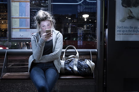 woman using smartphone while sitting inside vehicle thumbnail