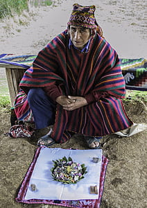 man sitting wearing robe in front of food outdoors thumbnail