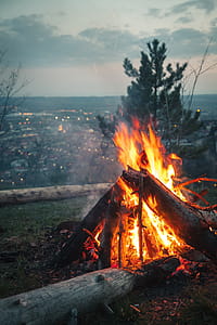 Photo of Bonfire Placed on High Ground in Front of City Under Cloudy Sky thumbnail
