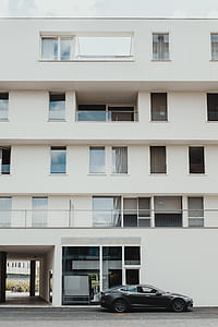 black sedan near concrete building thumbnail