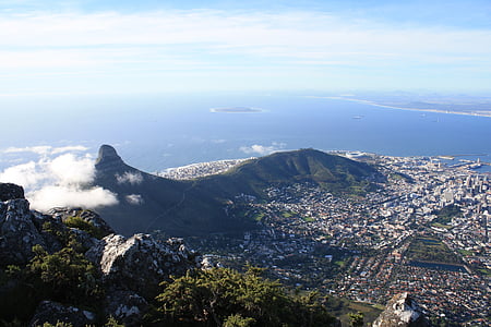aerial photography of the city, mountains, and ocean during day thumbnail