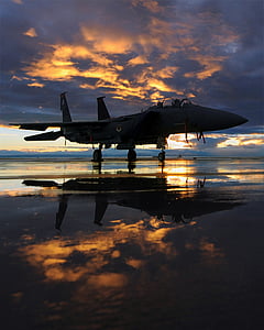 silhouette of airplane under cloudy sky during sunrise thumbnail