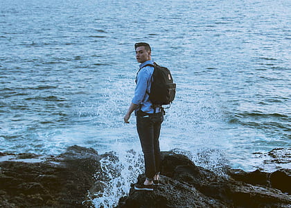 man standing near body of water thumbnail