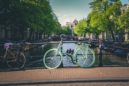 green step-through bicycle parked on brigde thumbnail