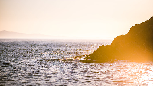 body of water near the cliff golden hour thumbnail