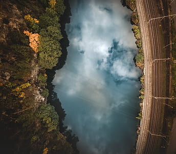 aerial photography of body of water near trees thumbnail