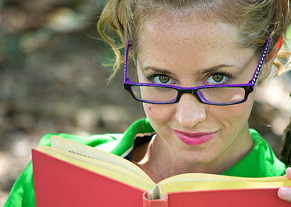 woman holding red hardbound book thumbnail