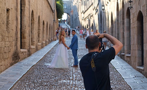 couple taking photo beside buildings thumbnail