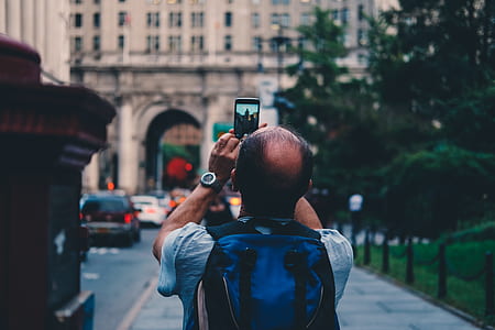 shallow focus photography of man taking a photo thumbnail