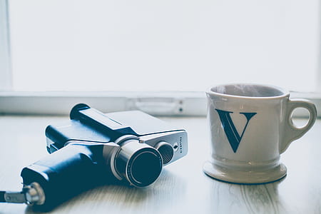 black camera and white ceramic mug thumbnail