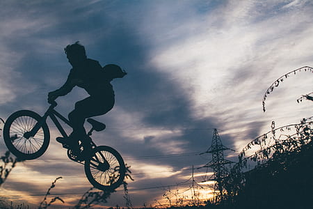 silhouette photo of person riding BMX bike thumbnail