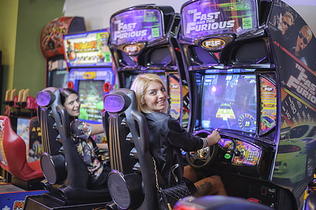 two women playing arcade games thumbnail