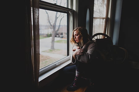 woman standing near window thumbnail