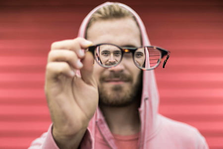 man holding sunglasses thumbnail