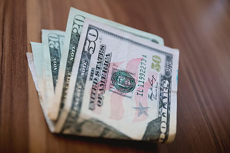 A few American dollars on the wooden table thumbnail