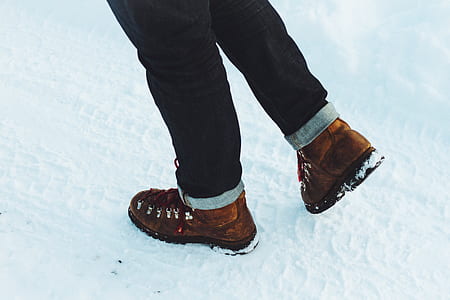 person wearing black jeans standing on snow covered groiund thumbnail
