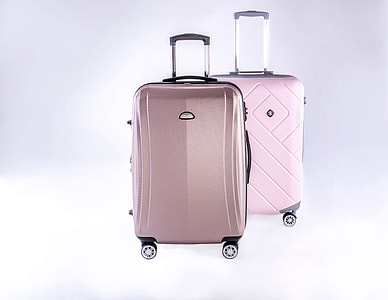 two pink hard travel luggages thumbnail