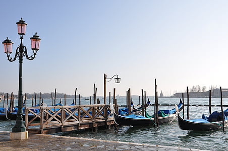 two blue boat on body of water near wooden dock during daytime thumbnail