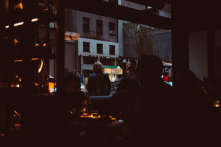 person sitting on chair near table inside cafe during daytime thumbnail