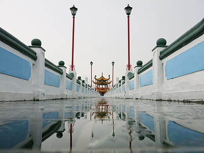 photo of white and blue pathway and torii gate during daytime thumbnail