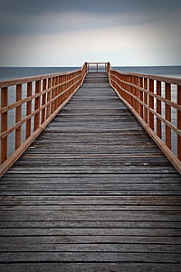 black and brown wooden dock near blue body of water under sky during daytime thumbnail