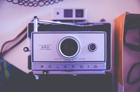 selective focus photography of Polaroid camera thumbnail