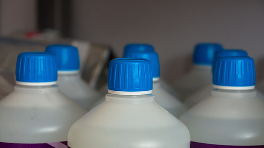 white-and-blue plastic bottles near wall thumbnail