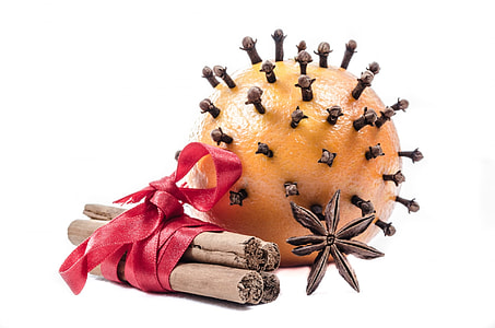 orange fruit with star anise and sticks rolled by red ribbon thumbnail