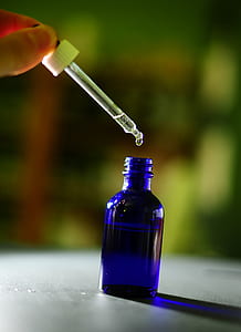 person pouring droplet of water in bottle thumbnail