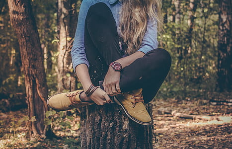 woman sitting on tree trunk outdoor thumbnail