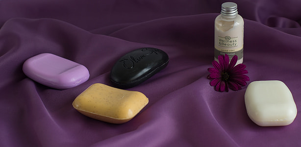 four assorted-color soap bars on purple textile thumbnail