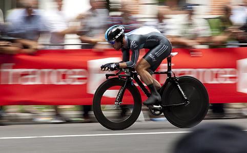 panning photo of man riding bicycle thumbnail