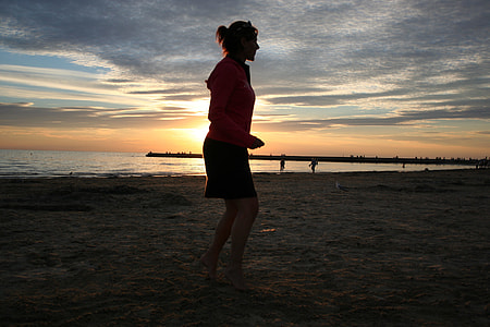 woman wearing pink long-sleeved shirt and black mini skirt outfit golden hour thumbnail