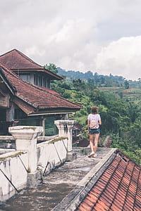 woman standing on gray concrete rooftop thumbnail